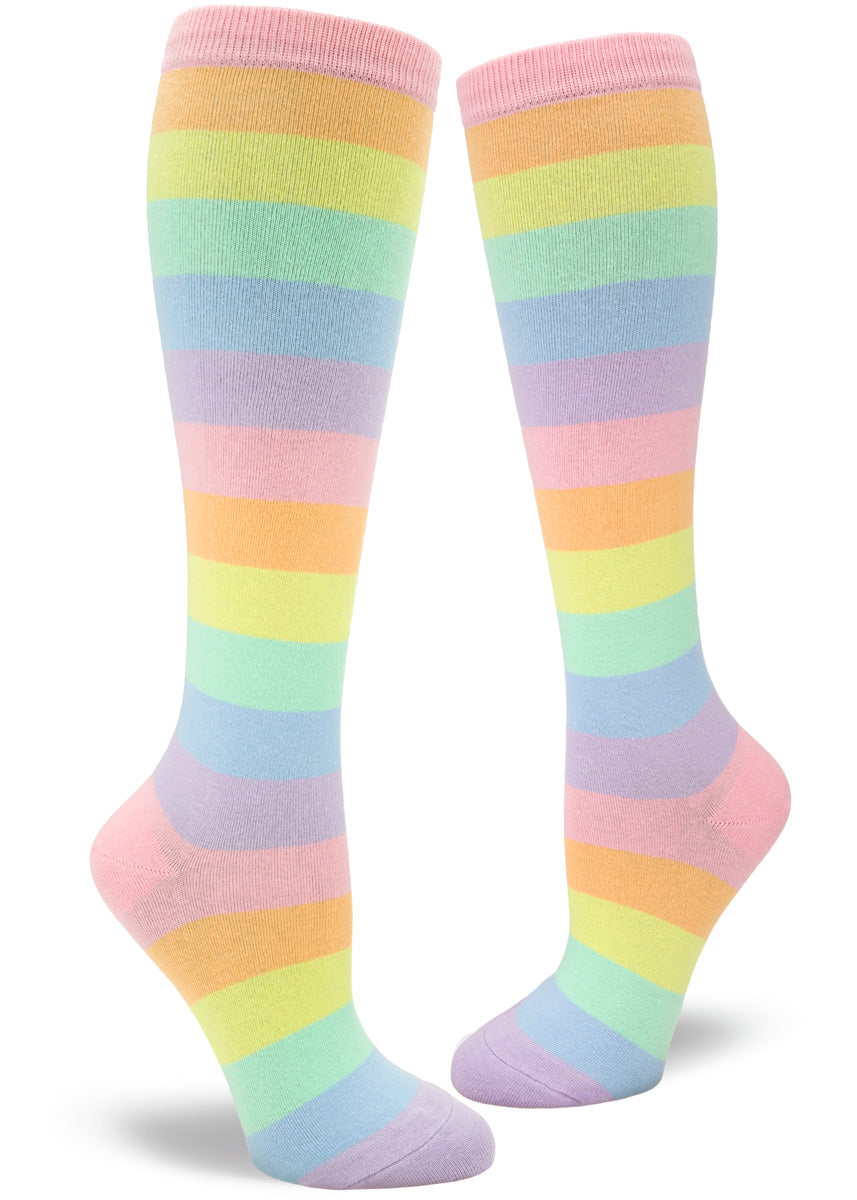 Knee high socks for women have pastel rainbow stripes in pale pink, orange, yellow, mint, blue, and purple.