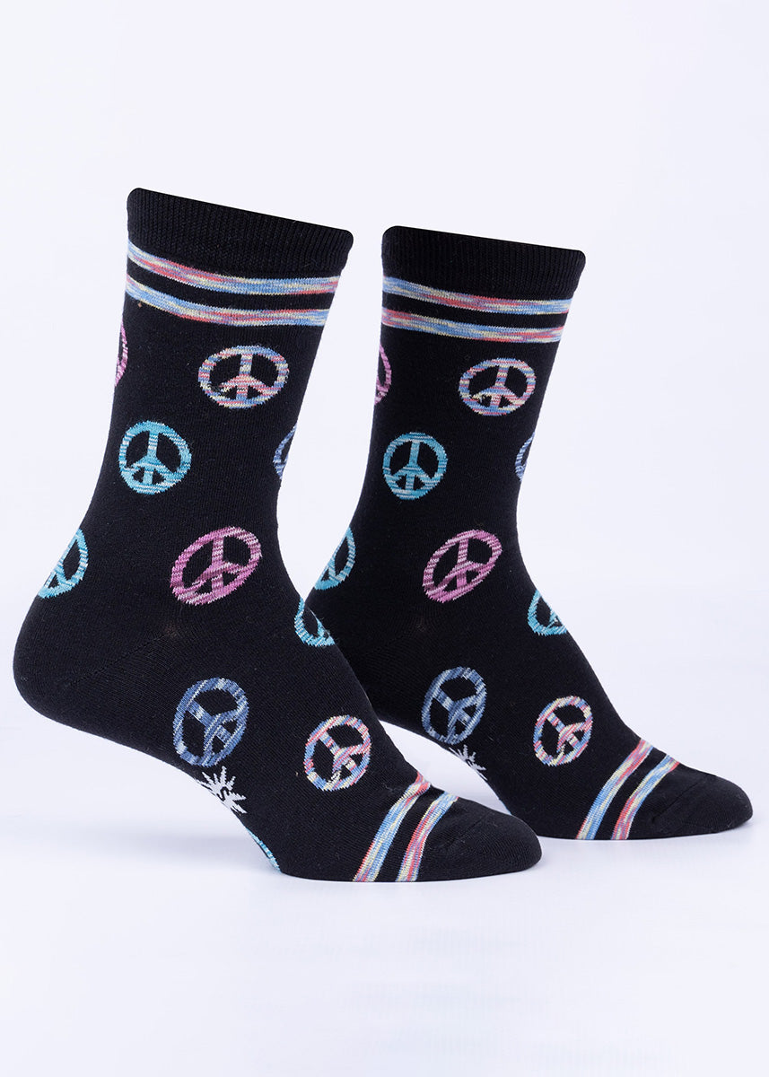 Black socks with a pattern of peace signs rendered in multi-colored space-dyed yarn.