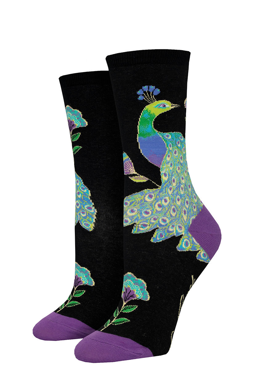 Artistic peacock socks for women in shades of teal, blue and purple on a black background, based on the designs of Laurel Burch.