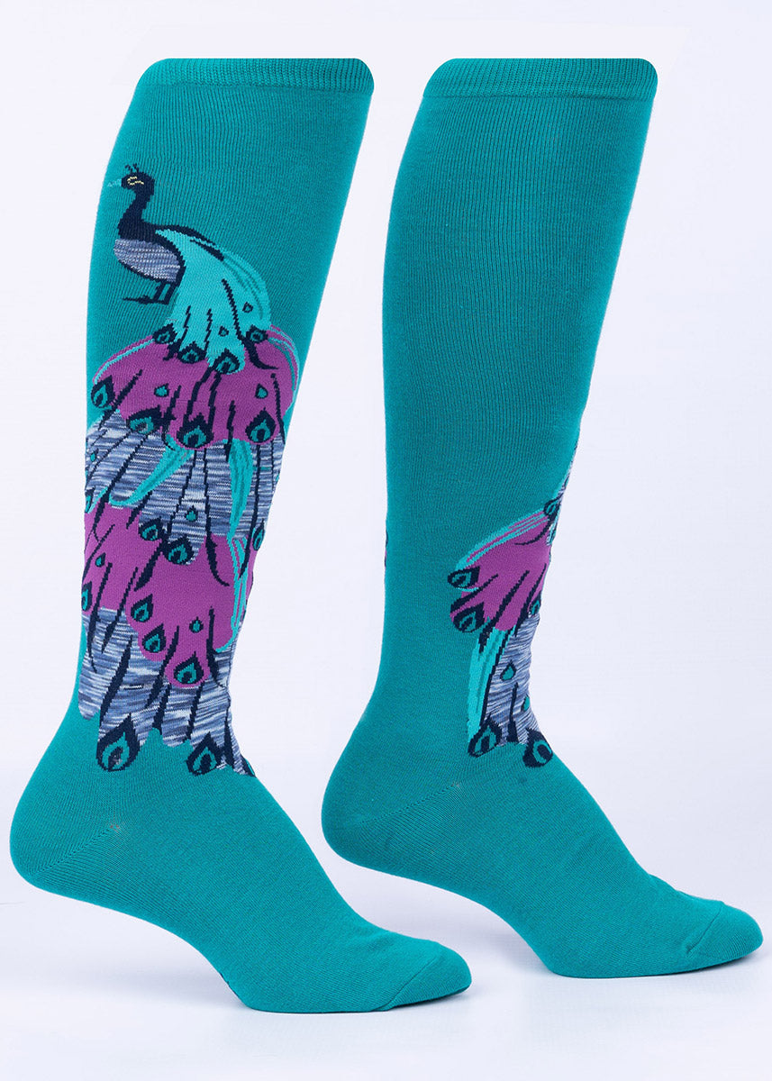 Knee-high socks with a peacock bird design, with his glorious purple and teal tail cascading down the leg.