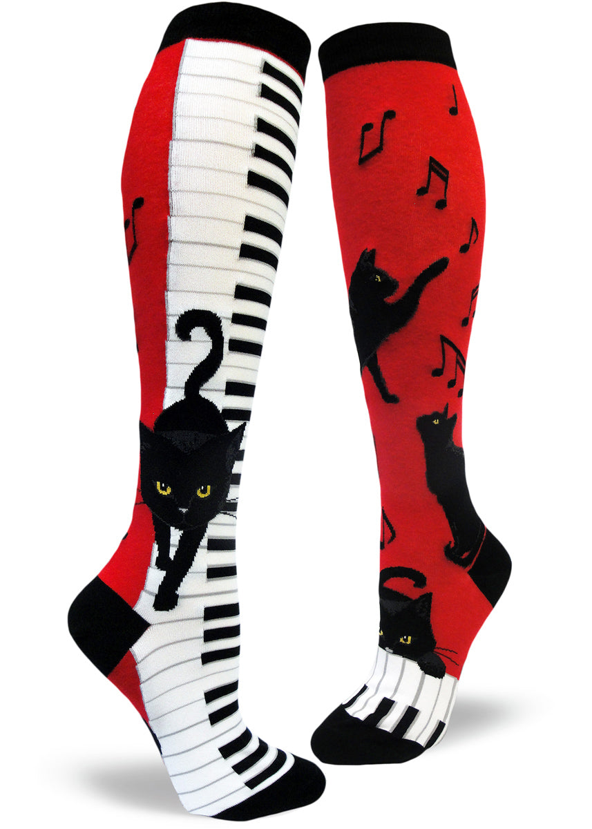 Piano cat socks for women with black cats playing piano and music notes on a red background