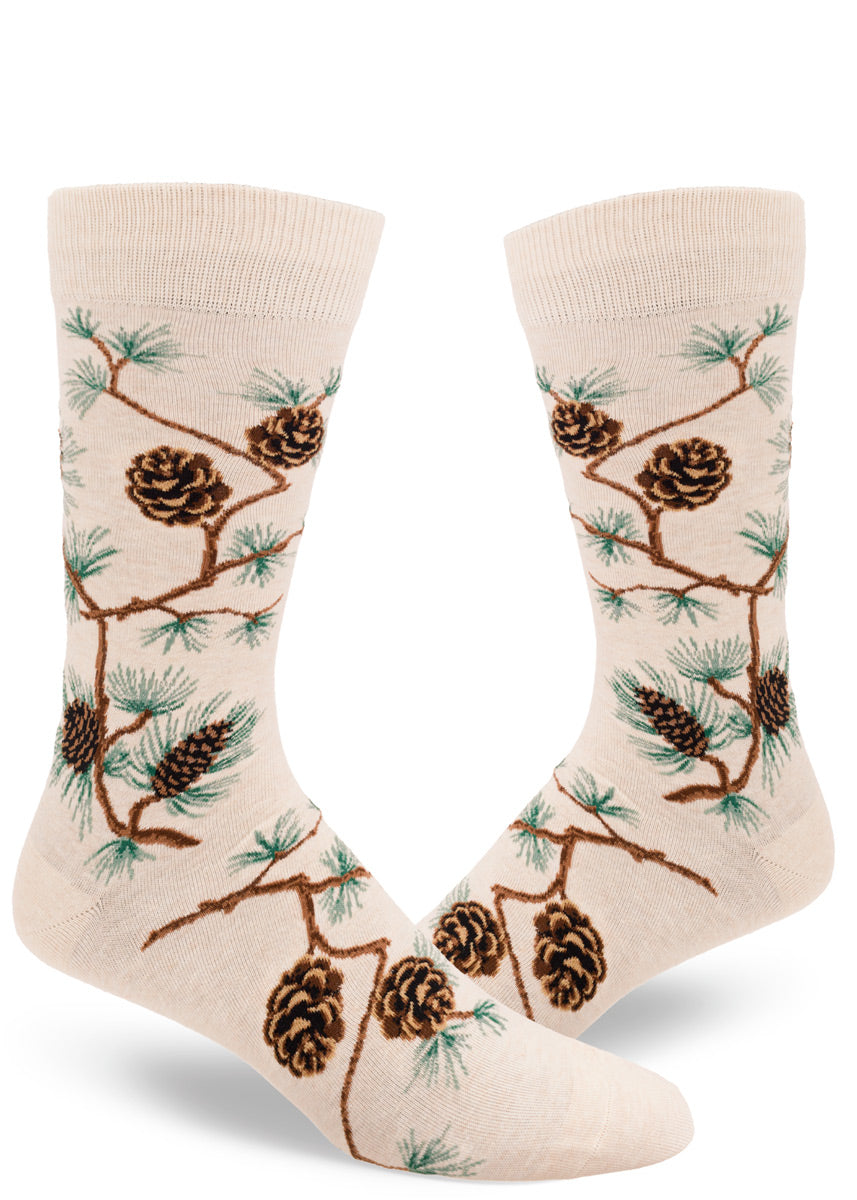 Nature socks for men feature pinecones on their branches on a cream background.