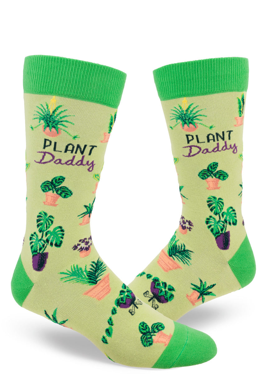 Green crew socks featuring an assortment of potted plants and the words “Plant Daddy.”