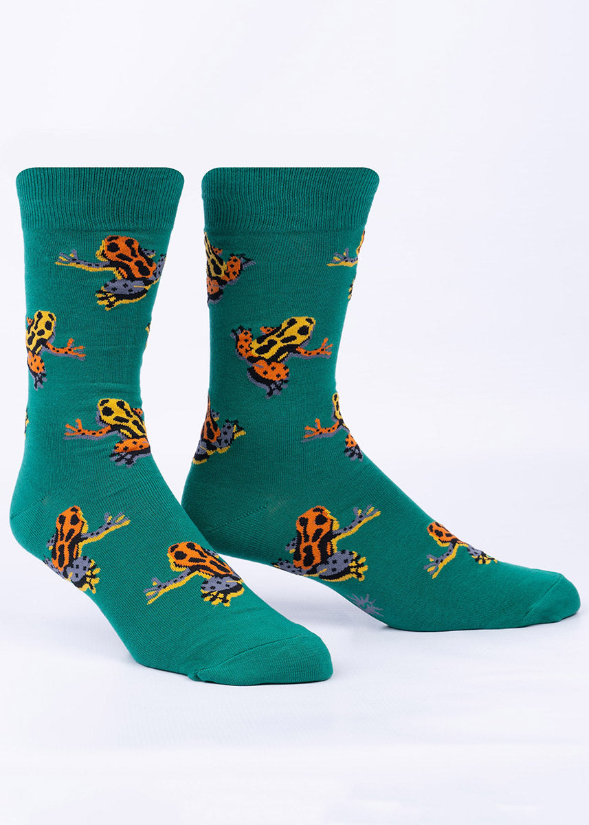 Green men&#39;s crew socks with a repeating pattern of colorful orange and yellow poison dart frogs.