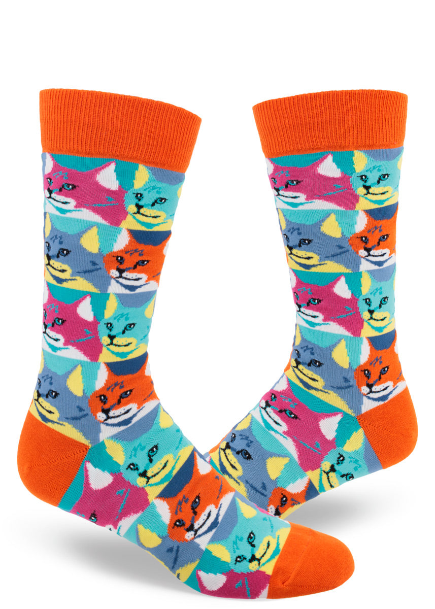 Colorful men's crew socks with an allover repeating pattern of a cat portrait, each cat face color blocked in bold hues to resemble the silkscreened pop art of the 1960s.