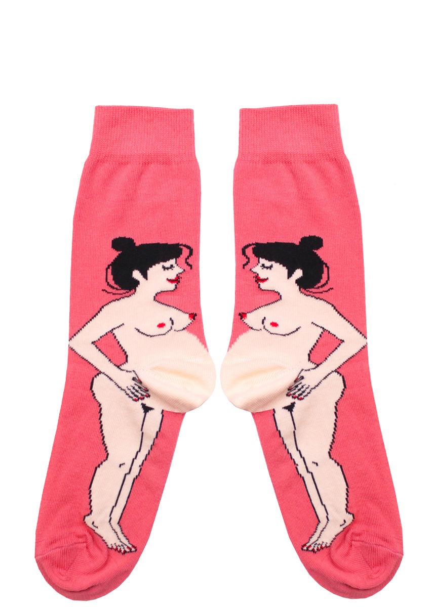 Funny pregnancy socks feature a nude pregnant woman with dark hair and pale skin, with her baby bump forming the heel of the socks and a bright pink background.