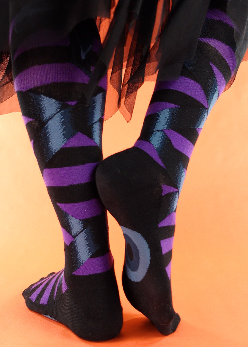Halloween knee socks feature dark blue ribbons tied around black and purple stripes!