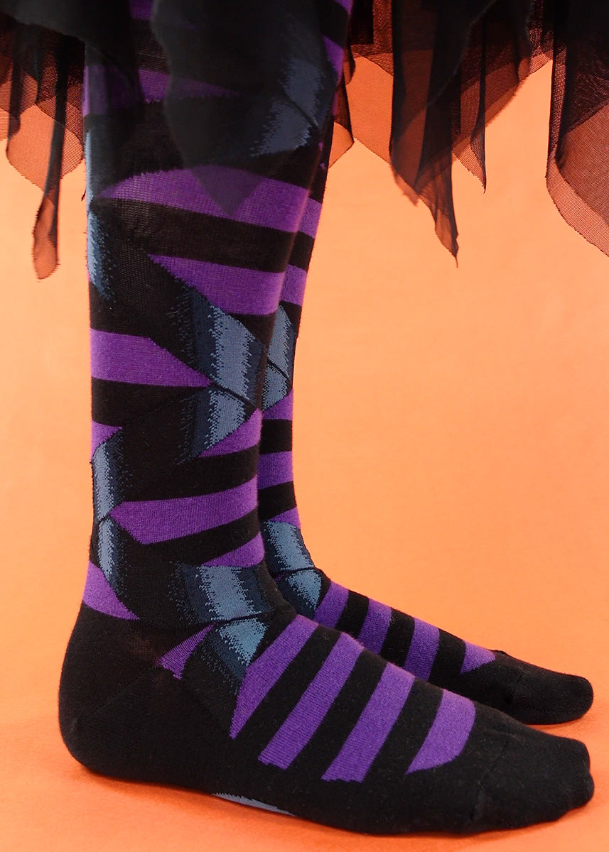 Striped goth knee socks feature faux ballet slippers with their ribbons tied in a bow.