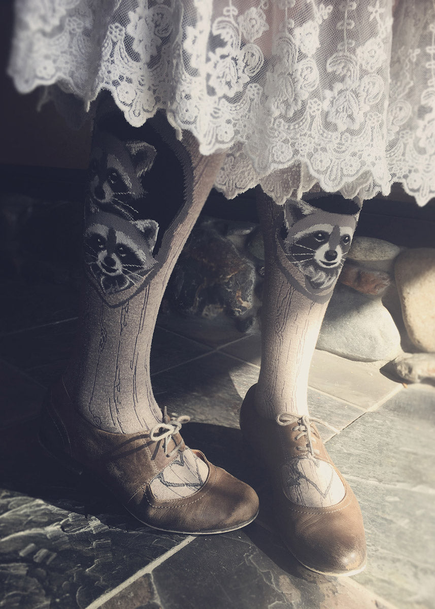 Knee socks for women show adorable raccoons peeking out of tree hollows!