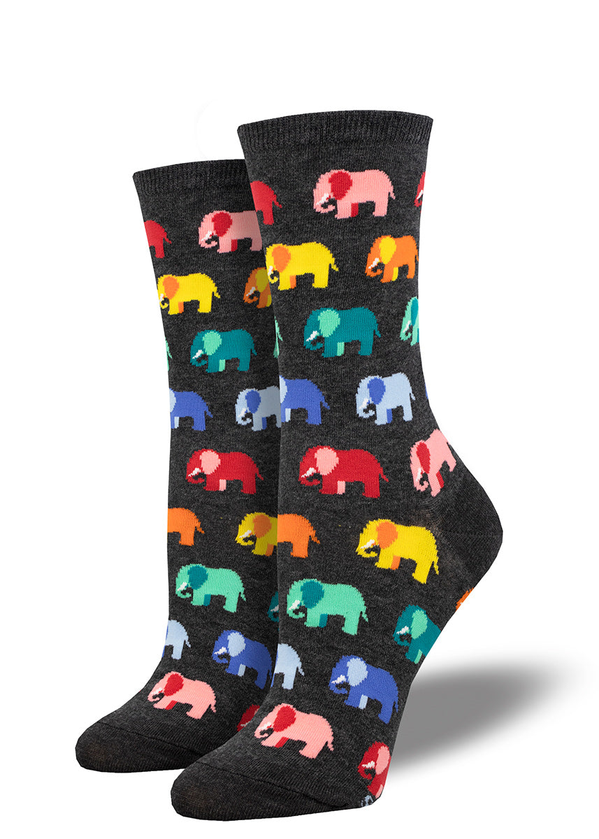 Women&#39;s crew socks feature a repeating pattern of elephants in rainbow colors over a heather charcoal background.