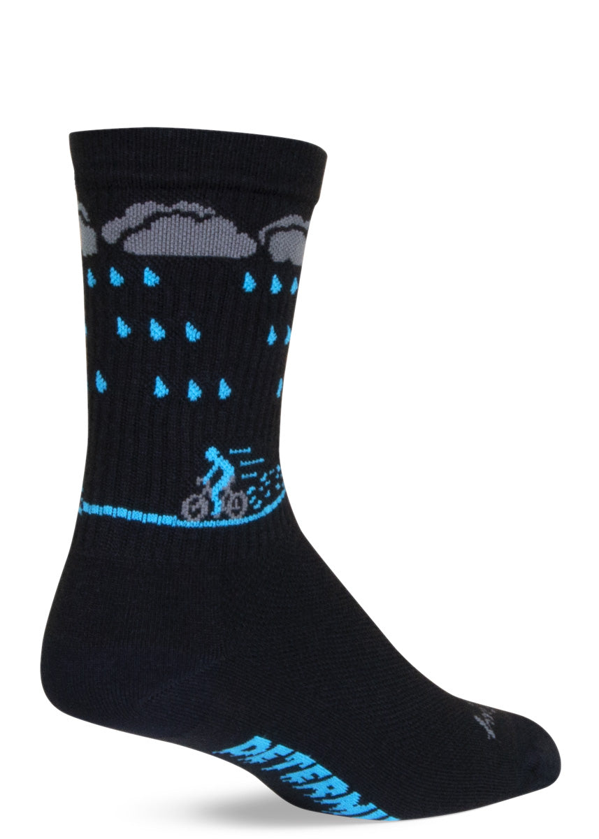 Funny athletic socks show a person biking in the rain with the word "Determined" written on the bottom of the foot. 