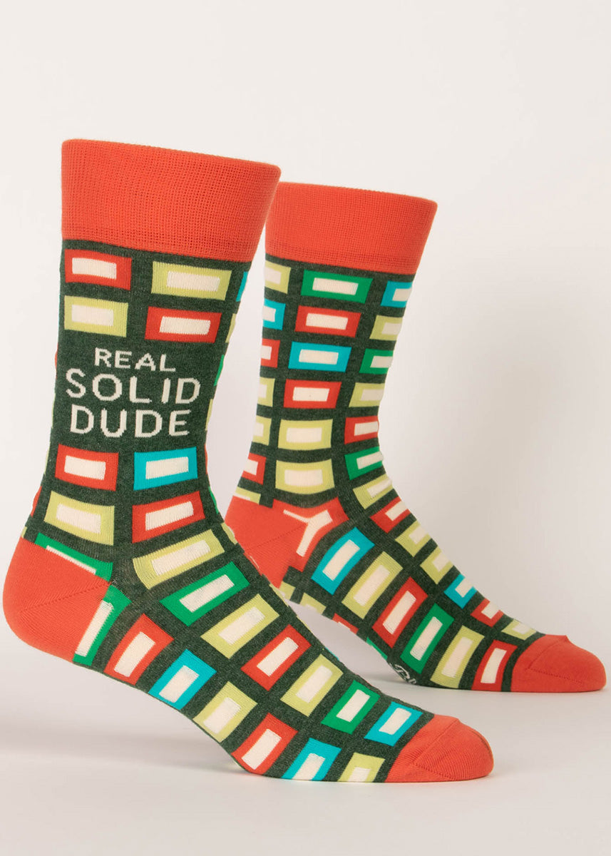 Colorful men&#39;s crew socks with a bold brick pattern and the words “Real Solid Dude.&quot;