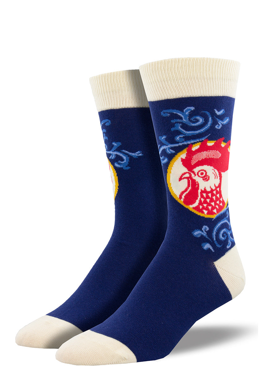 Crew socks for men feature a red portrait of a rooster with blue filigree details on a dark blue background.