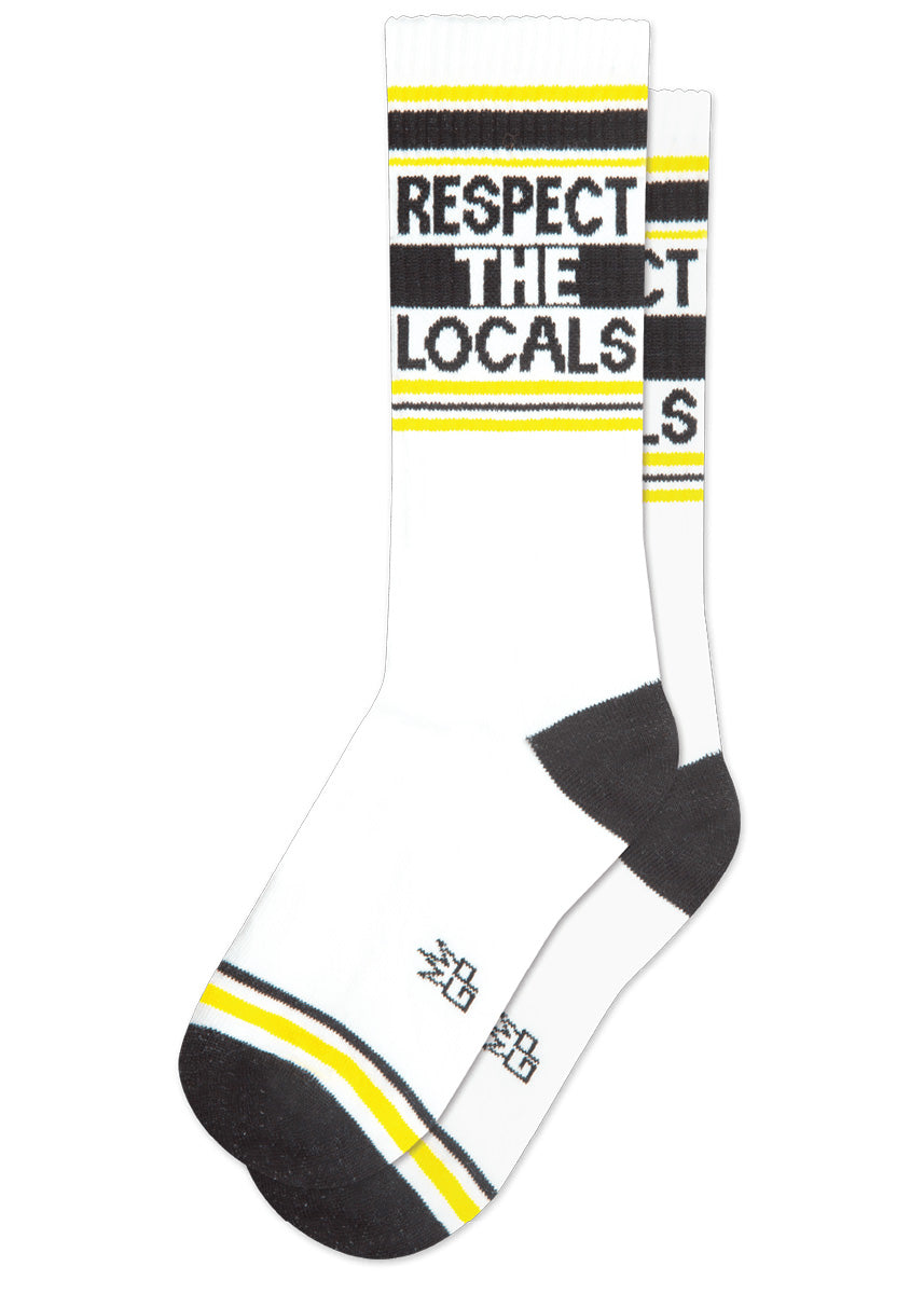White retro gym socks with black and yellow stripes and the phrase “RESPECT THE LOCALS&quot; on the leg.