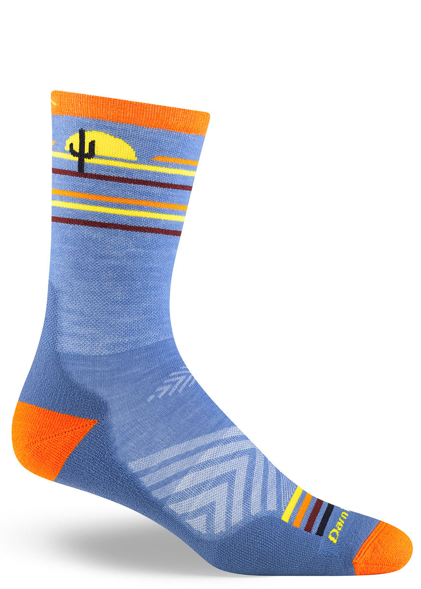 Blue wool running socks for men with a pattern around the cuff depicting a striped desert sunset and a speeding roadrunner bird.