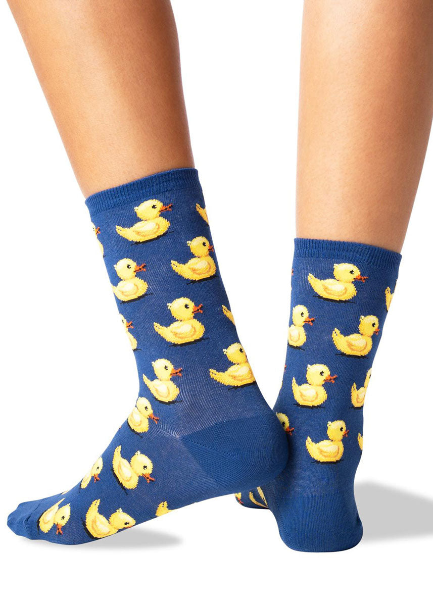 Navy blue crew socks for women with a repeating pattern of yellow rubber duck toys.