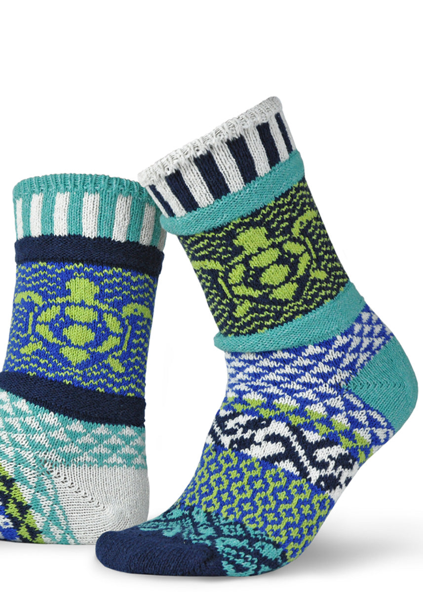 Funky mismatched socks feature patterns in blues, greens, and whites with a sea turtle design!
