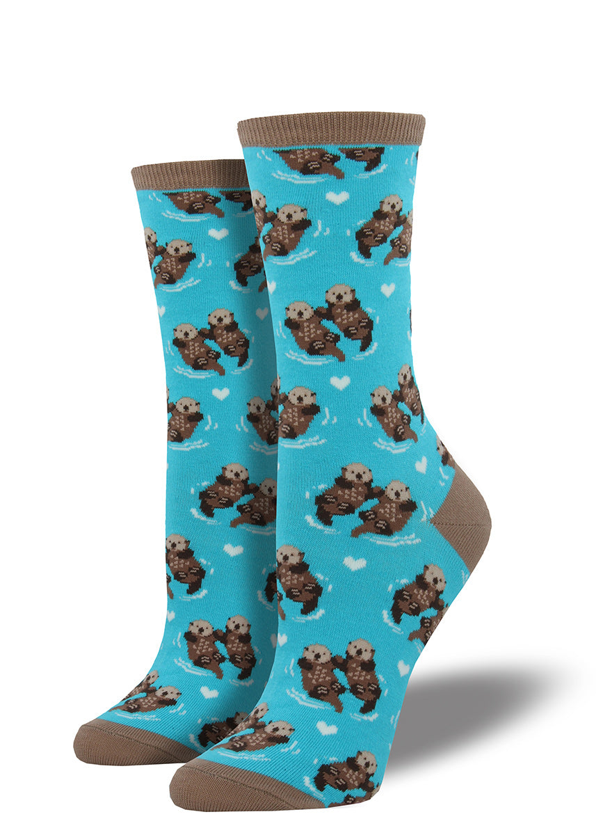 Adorable otter couples hold hands while they float on these crew socks for women.