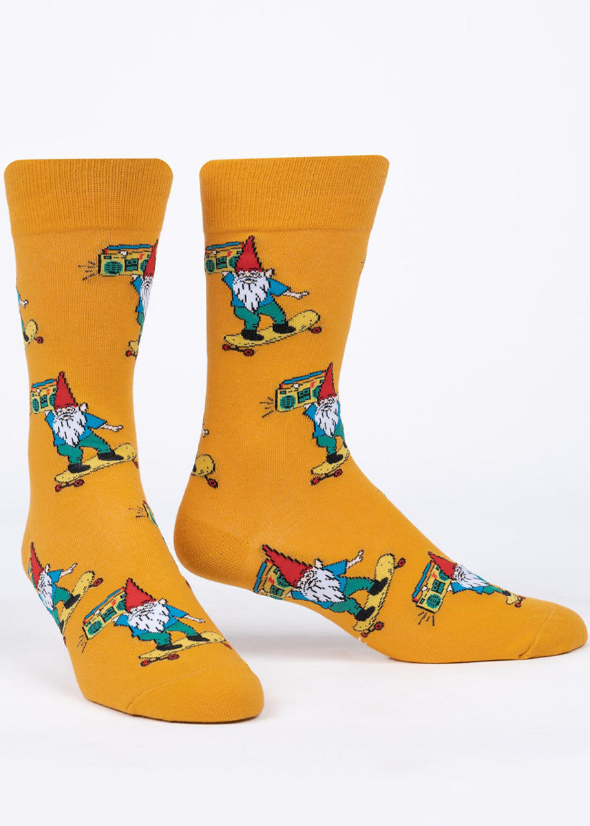 Funny socks for men feature gnomes on skateboards carrying boomboxes on a warm yellow background!