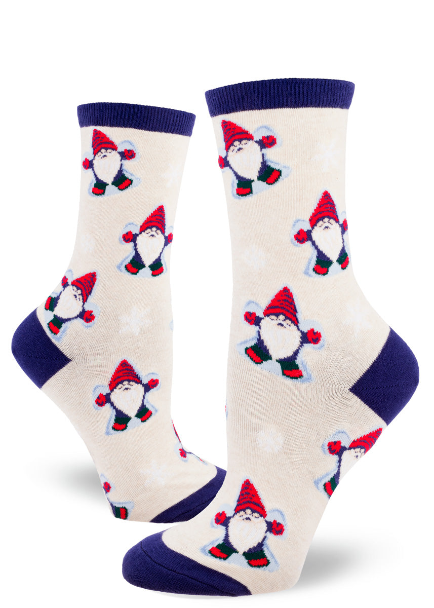 Cute winter socks for women show gnomes bundled up in hats and gloves making snow angels!