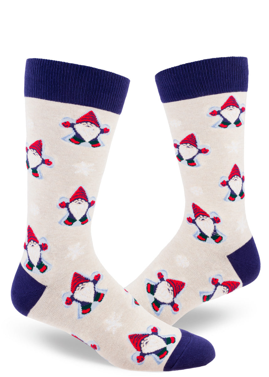 Winter crew socks for men show little gnomes making snow angels on a taupe background with navy accents.