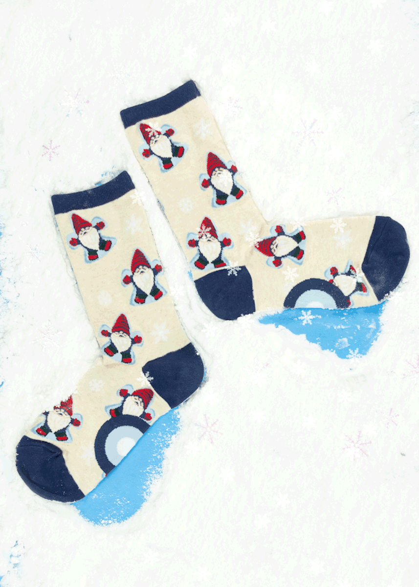 A GIF of gnome and snow-themed novelty socks making &quot;sock angels&quot; in the snow while snowflakes fall from above. 