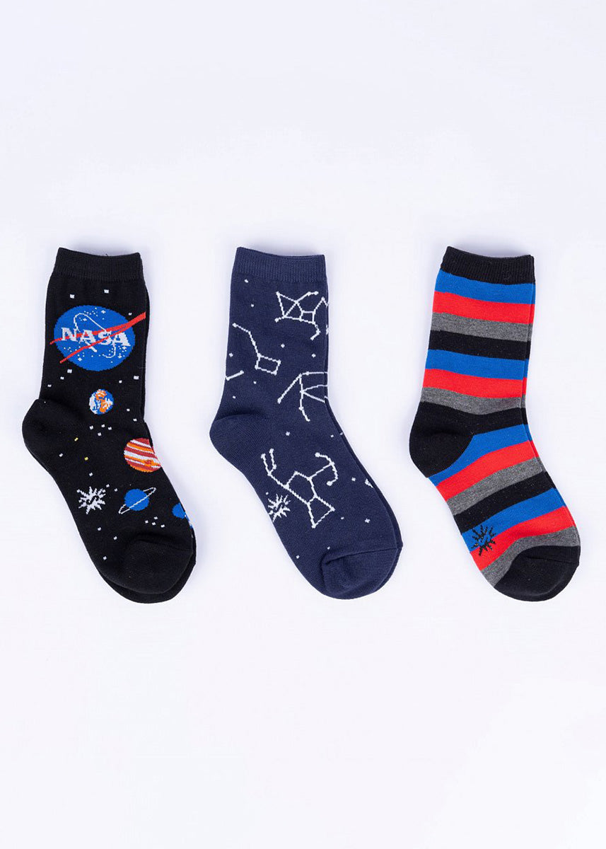 Three pairs of coordinating navy, blue and red socks for kids in a space theme.