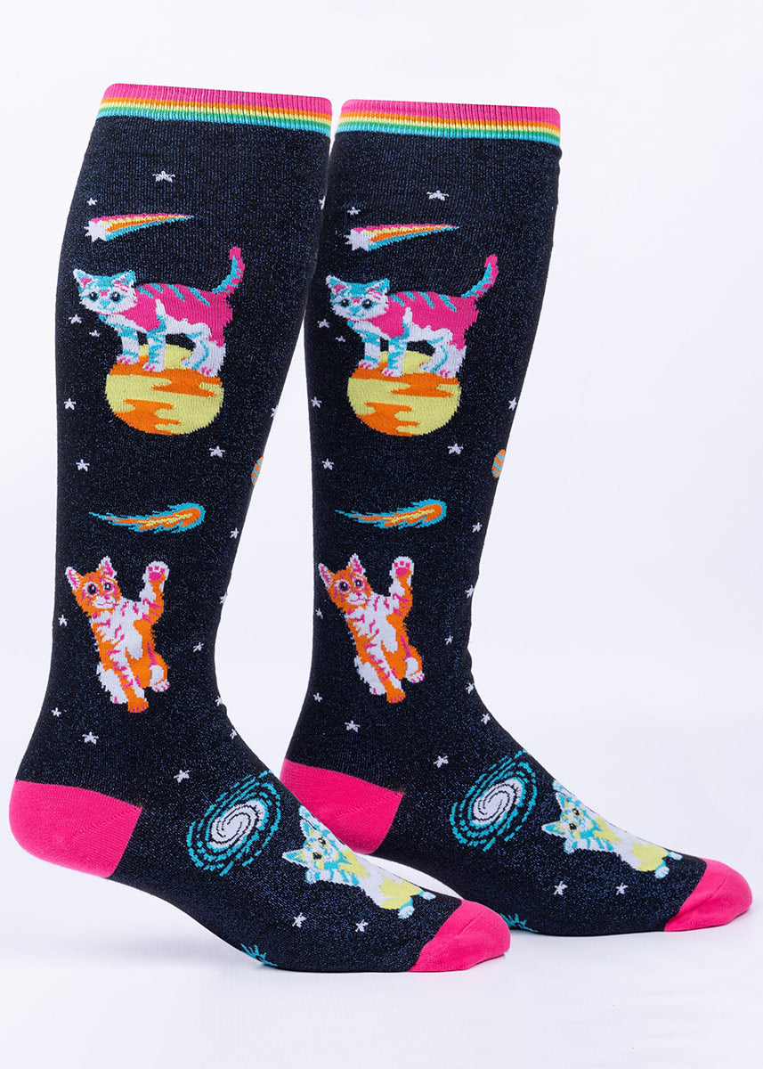 Knee socks with a dark blue metallic on black background depict colorful cats in space among comets, stars and planets.