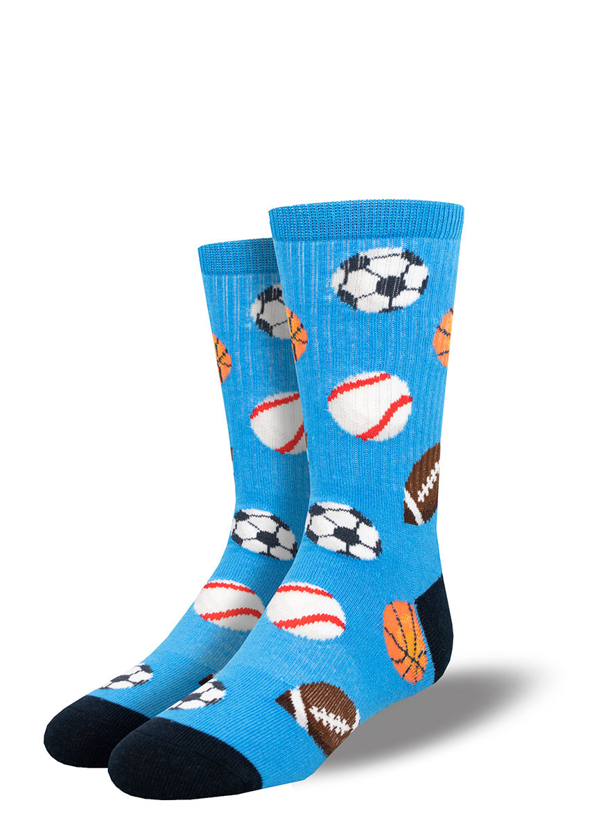 Fun blue athletic socks for kids covered in baseballs, basketballs, soccer balls and footballs.