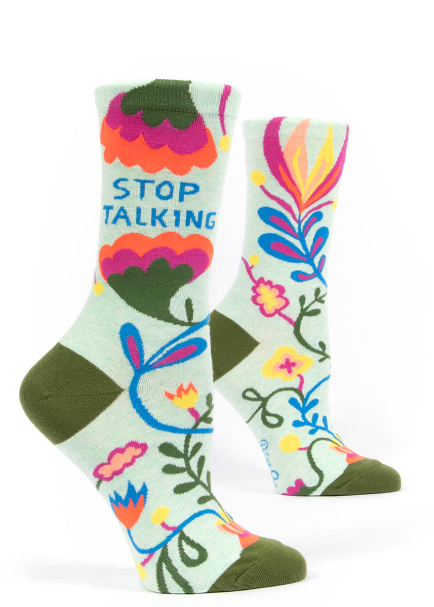 Crew socks for women feature colorful abstract floral designs with the words, &quot;Stop Talking!&quot;