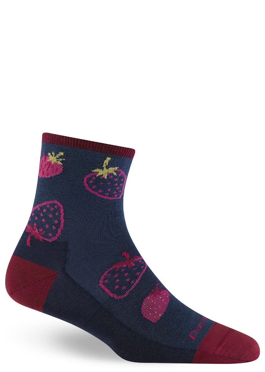 Navy ankle socks made of merino wool with a pattern of magenta strawberries and burgundy accents at the heel, toe and cuff.