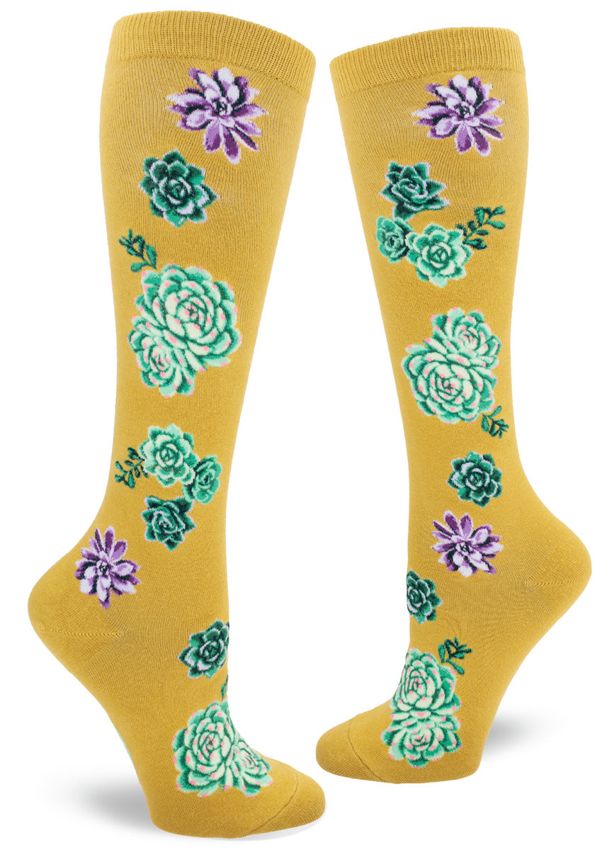 Chartreuse knee socks with a succulent plants design rendered in shades of purple, green and pink.