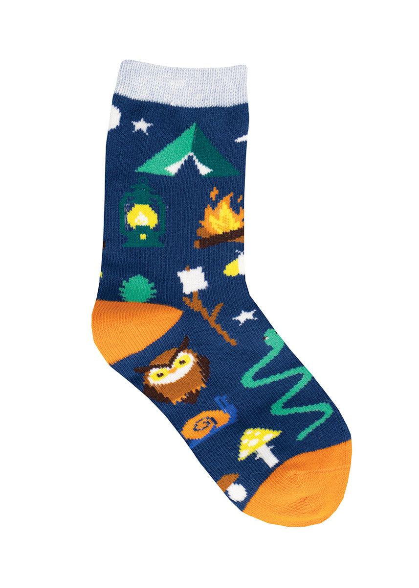 Novelty crew socks for kids feature woodland creatures, a campfire, camping gear and a toasted marshmallow on a blue background.