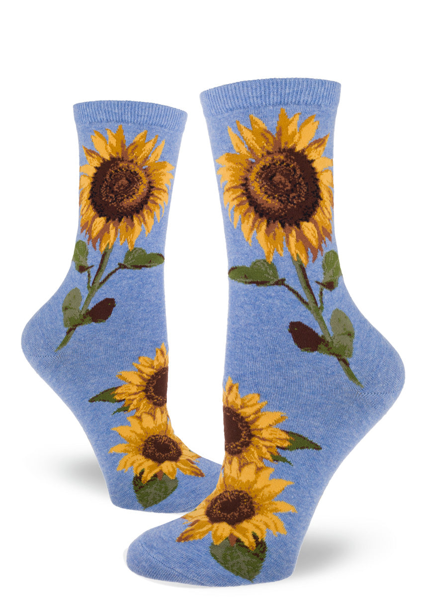 Crew socks for women feature golden summer sunflowers on a cornflower blue background.