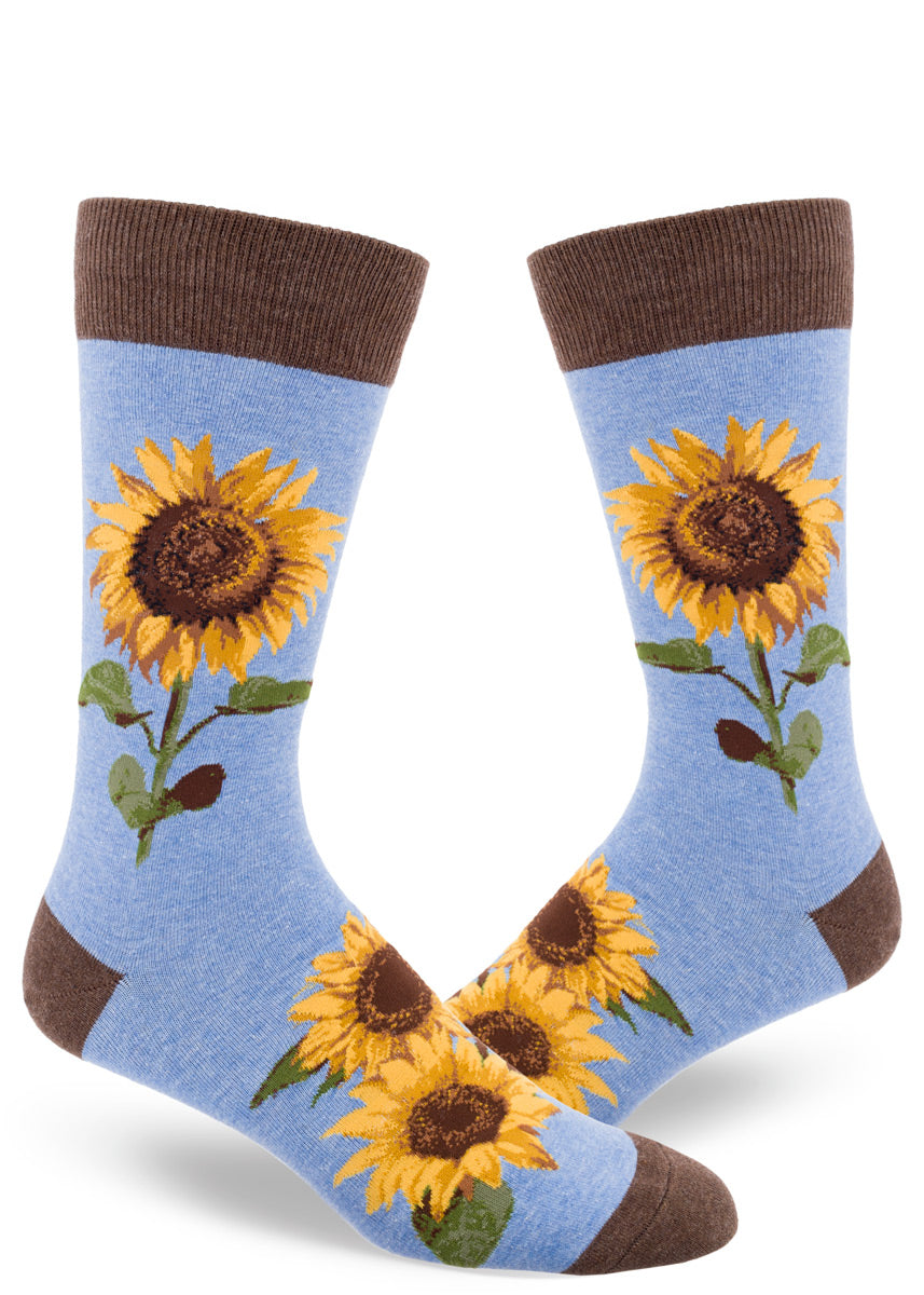 Sunflower socks for men feature realistic golden sunflowers on a light blue background with brown cuffs, toes, and heels.