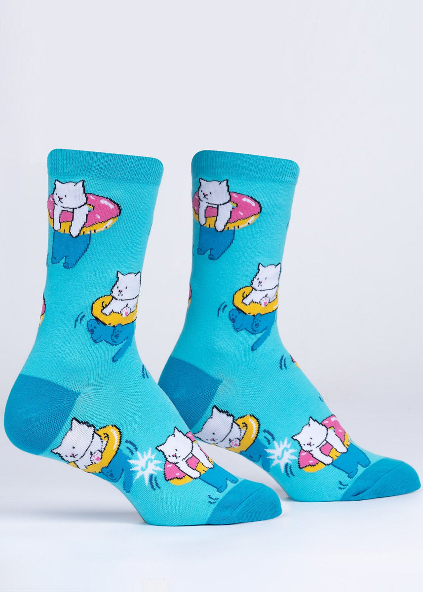 Novelty cat socks with a design featuring cute white kitties floating in donut pool toys.