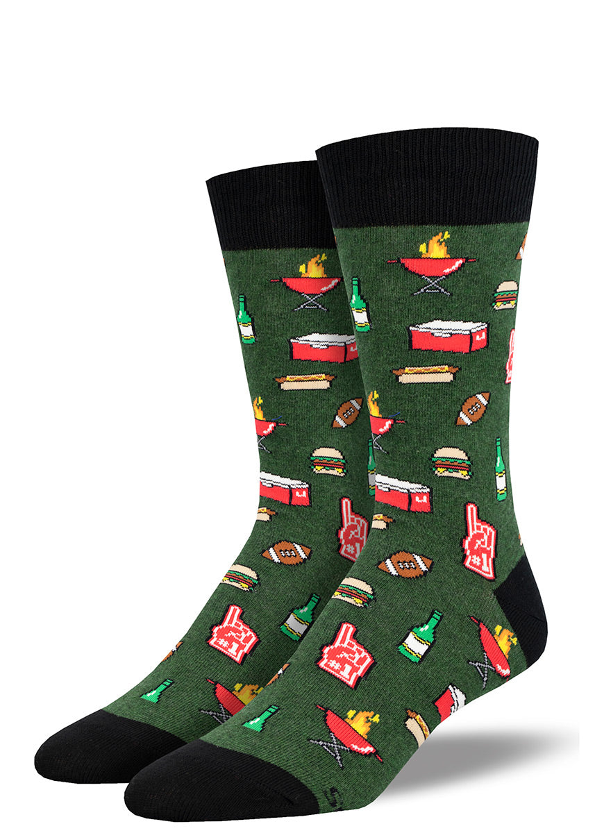 Men's novelty crew socks with a tailgating-themed design of foam fingers, footballs, beer bottles and coolers, grills and barbecue food like hotdogs and hamburgers.
