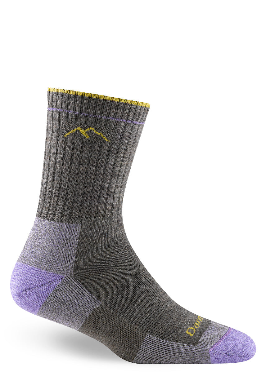 Crew-height cushioned merino wool hiking socks for women from Darn Tough, shown in a taupe colorway with gold and lavender accents.
