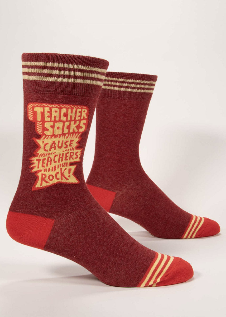Heather maroon men&#39;s crew socks with red accents and retro schoolhouse-styled lettering that says &quot;Teacher Socks &#39;Cause Teachers Rock!”