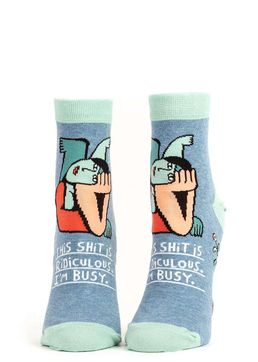 Funny ankle socks for women show a woman resting her head on her hand with the words, "This shit is ridiculous. I'm busy."
