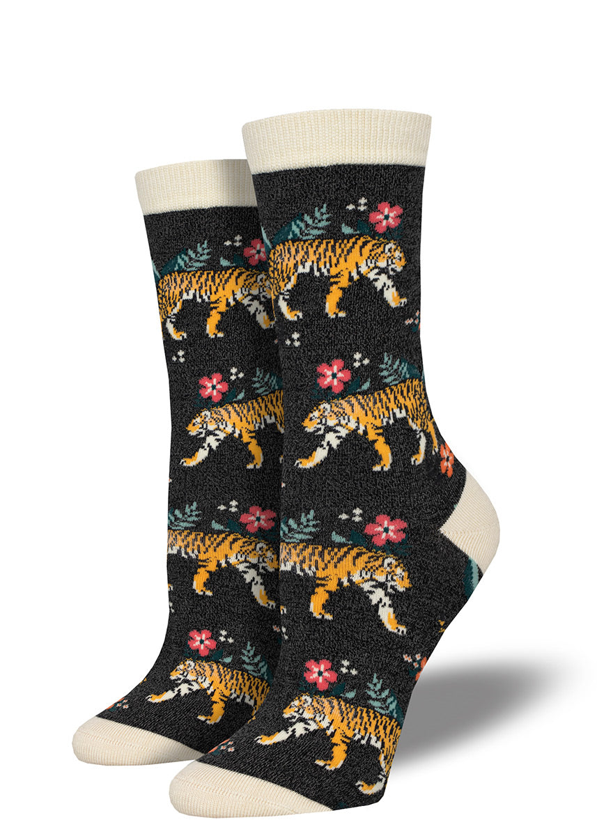 Dark charcoal bamboo crew socks for women with a repeat pattern of tigers stalking their way through a jungle scene of ferns and flowers.