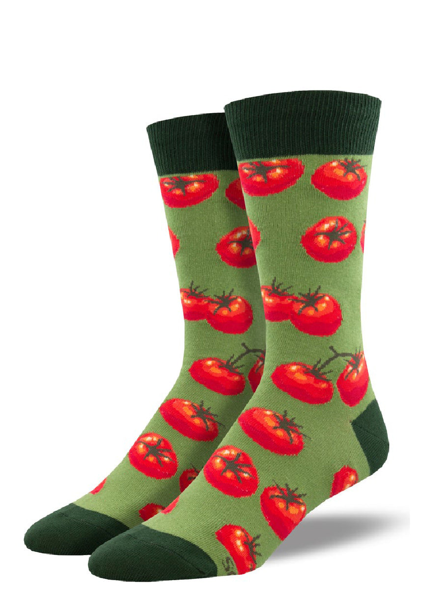 Green novelty socks for men covered in a pattern of red tomatoes.