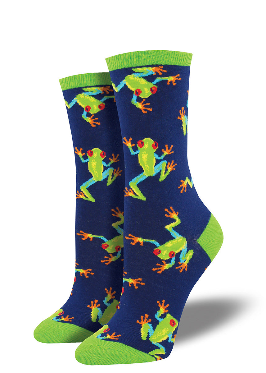 Cute frog socks for women feature tropical tree frogs with green bodies and red eyes on a navy blue background.