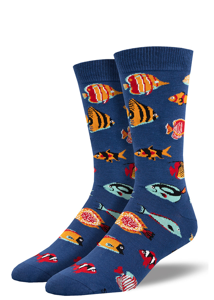 Navy men's crew socks feature a pattern of tropical fish including clownfish, butterflyfish and angelfish depicted in red, orange and aqua colors.