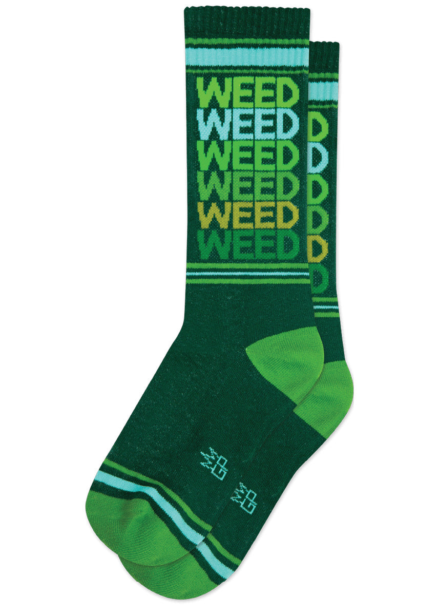 Funny retro gym socks say &quot;Weed&quot; repeated down the cuff in green font on a dark green background.