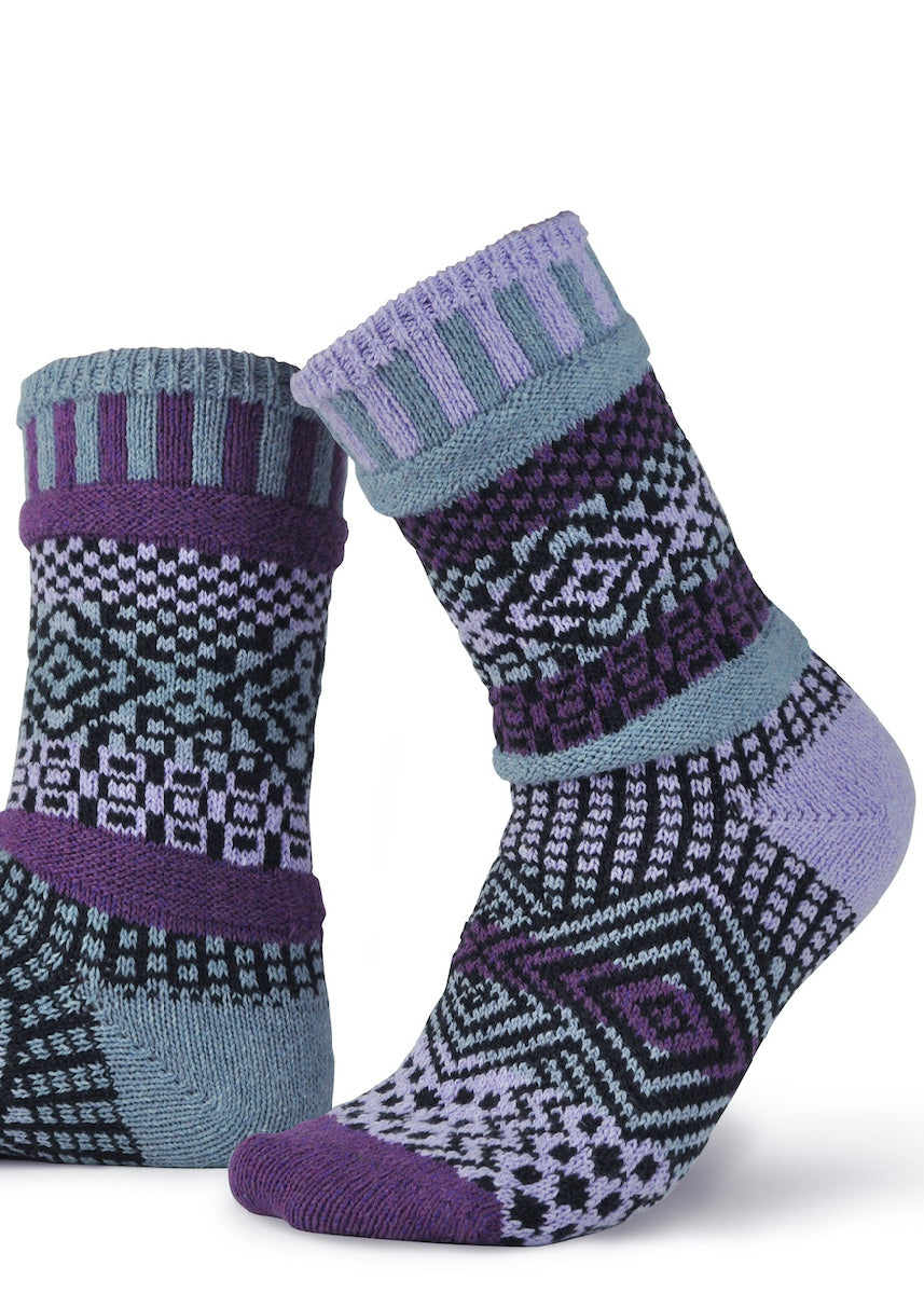 Funky patterned socks are intentionally mismatched and feature shades of dark purple, light purple, cool gray, and black!