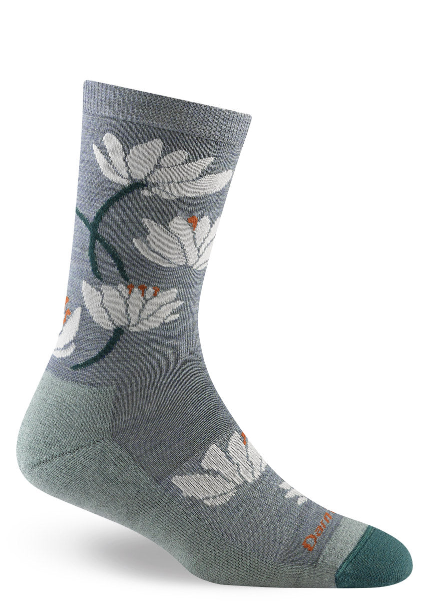 Wool crew socks in shades of aqua and teal featuring white water lily florals and a lightly-cushioned sole.