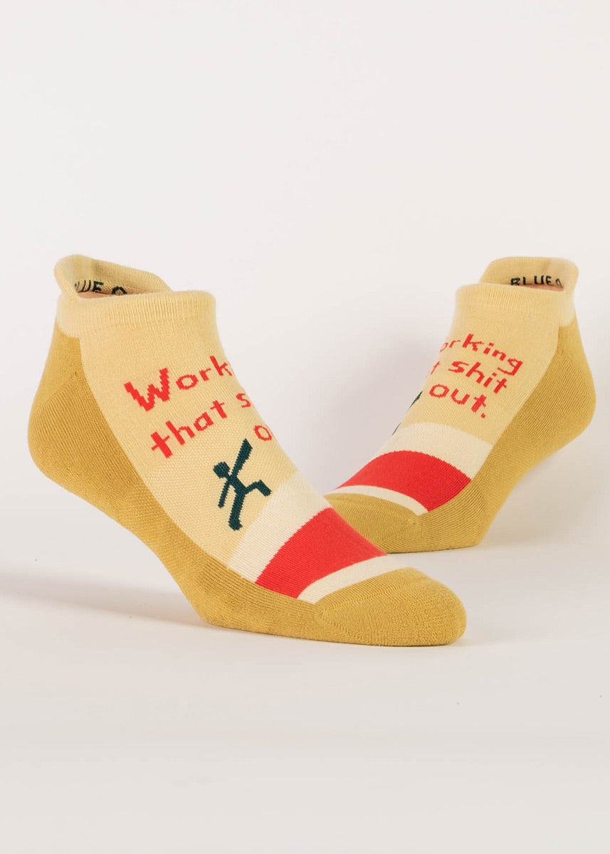 Yellow athletic ankle socks that say “Working that shit out.” 
