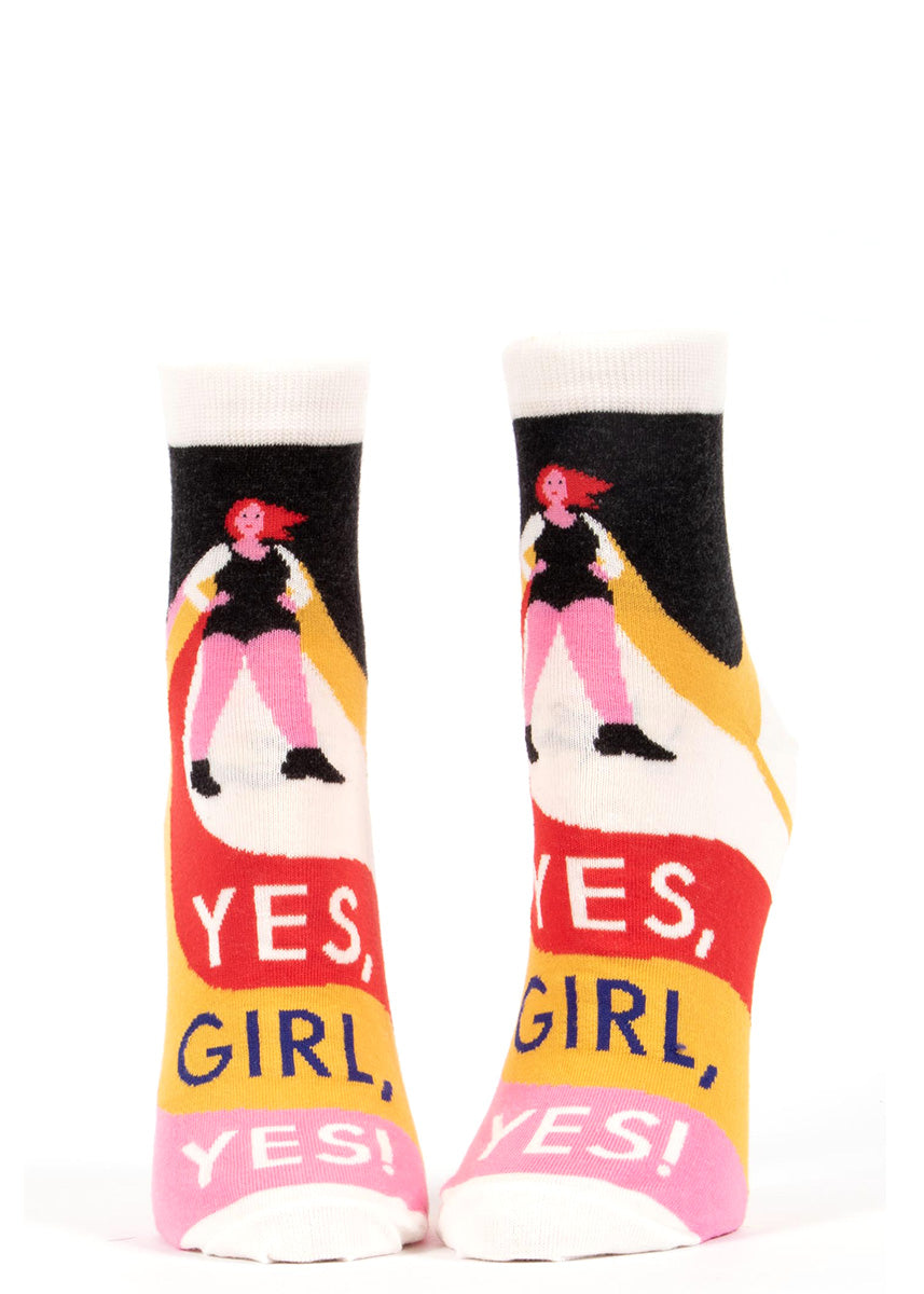 Ankle socks for women show a woman in a cape doing a superhero pose with the words, "Yes, girl, yes!" below her.